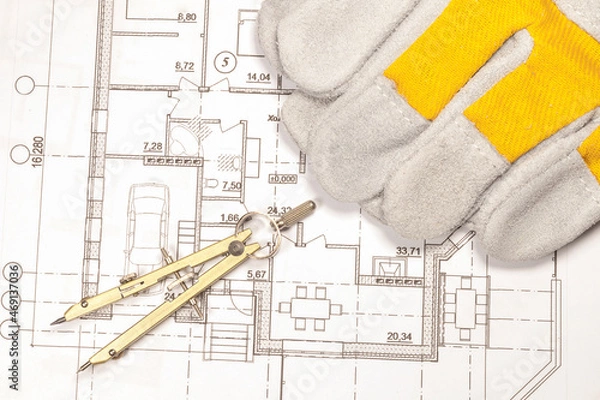 Fototapeta Calculation of the house according to the engineering plan. Work gloves and compasses are on the printed plan of the house.