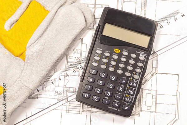 Obraz Work gloves, engineer calculator and ruler on the house plan. 