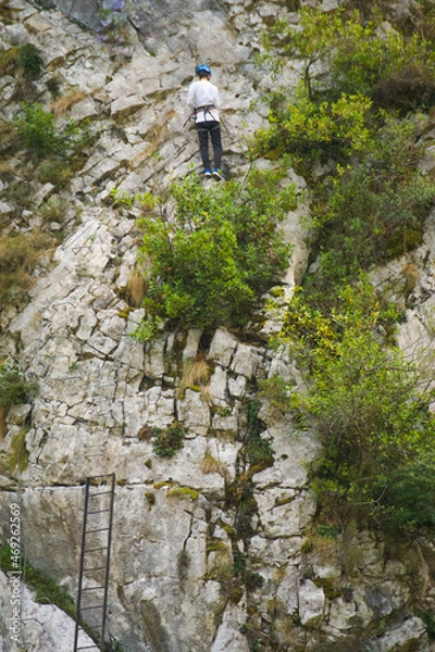 Obraz Climber man climbing the challenging route on a rocky mountain.