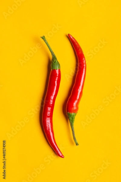 Obraz Chilli peppers on yellow background with copy space