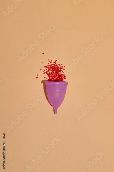 Fototapeta Menstrual cup on color background. Alternative feminine hygiene product during the period. Women health concept. Copy space. Eco friendly concept, zero waste product. Flat lay, mockup, template