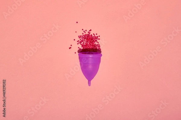 Fototapeta Menstrual cup on color background. Alternative feminine hygiene product during the period. Women health concept. Copy space. Eco friendly concept, zero waste product. Flat lay, mockup, template