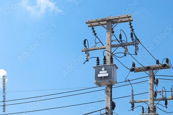 Fototapeta Cement high voltage electric pole power with transformer and drop fuse and blue sky copy space.
