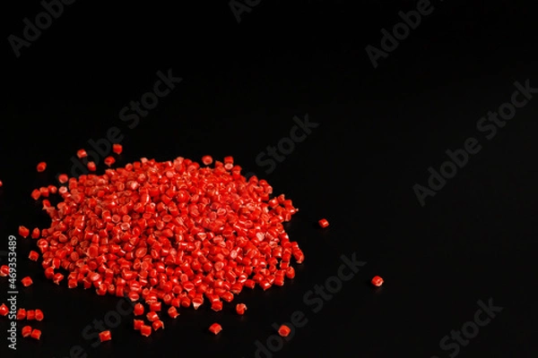 Fototapeta Many red granules of polypropylene, polyamide. Background. Plastic and polymer industry, industry. Microplastic products.