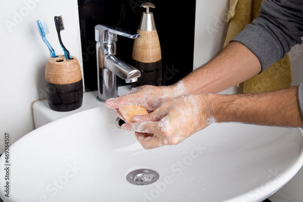 Obraz man washing his hands with plenty of foam due to the covid-19 pandemic