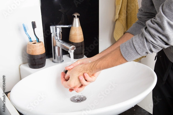 Obraz man washing his hands with plenty of foam due to the covid-19 pandemic