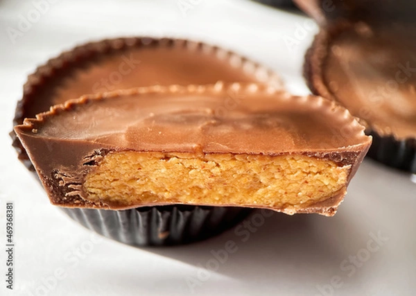 Fototapeta Close up macro shot of Peanut butter filled candy with chocolate frosting