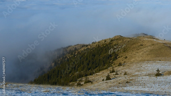 Fototapeta Mountain crest in a sea of clouds