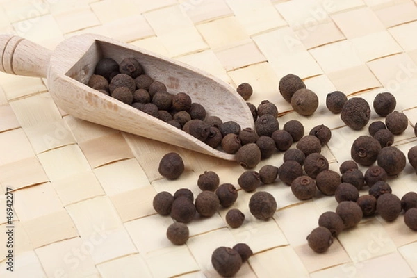 Obraz Allspice berries on a table mat