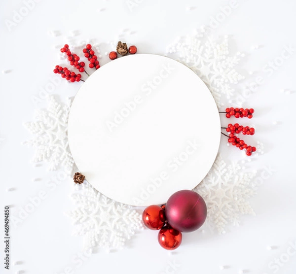 Obraz Christmas round white frame with sparkle snowflakes, red berries, baubles and snow ornaments on white background. Winter holidays and New Year composition. Flat lay.