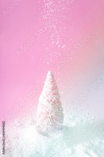 Fototapeta Christmas pink tree with falling snow with pink and icy blue light. Winter holidays and New Year idea. Vaporwave 80s and 90s aesthetic.