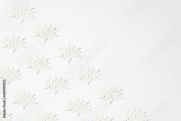 Obraz Christmas creative pattern made of white snowflakes with sparkle on white background. Winter holidays and New Year monochrome aesthetic layout.