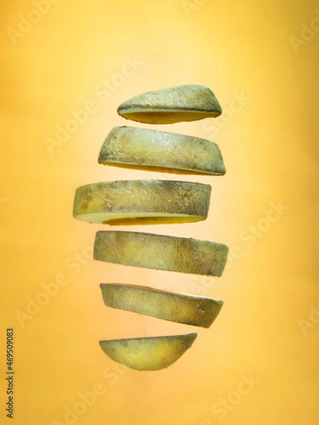 Obraz Chopped floating potato on orange background