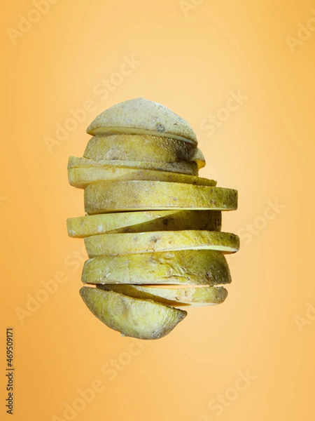 Obraz Potato slices floating on orange