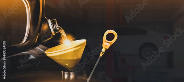 Fototapeta Mechanic pouring motor oil to engine with copy space on black background,Double exposure concept