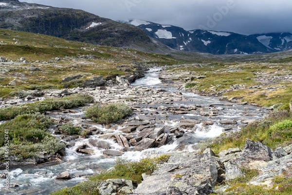 Fototapeta Small stream running through rocky terrain in Norway’s mountainous wilderness.