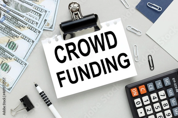 Fototapeta CROWD FUNDING. notepad on gray background business concept
