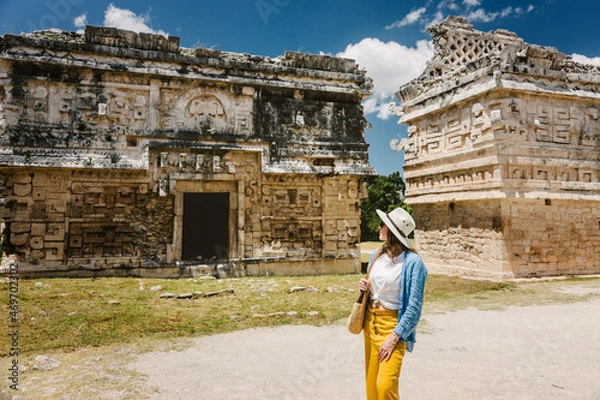 Fototapeta Girl tourist walks through the ancient Mayan complex Chichen Itza.A popular tourist destination in the Yucatan - Chichen Itza complex