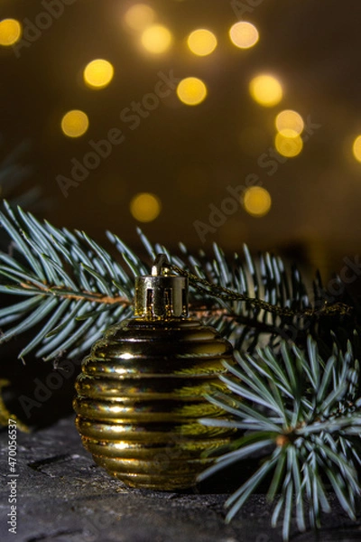 Fototapeta Golden Christmas ball on the Christmas tree. Selective focus. Bokeh background.