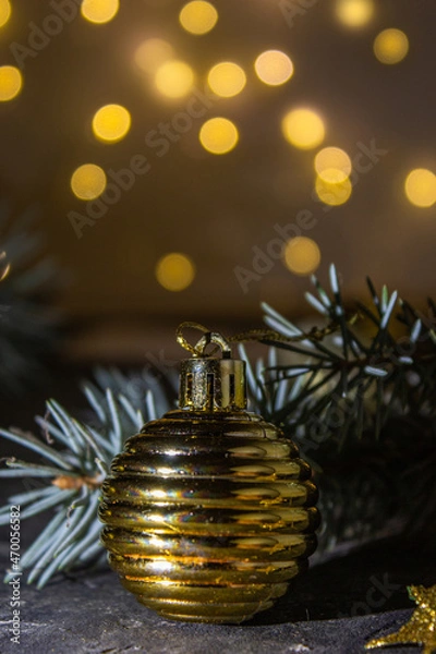 Fototapeta Golden Christmas ball on the Christmas tree. Selective focus. Bokeh background.