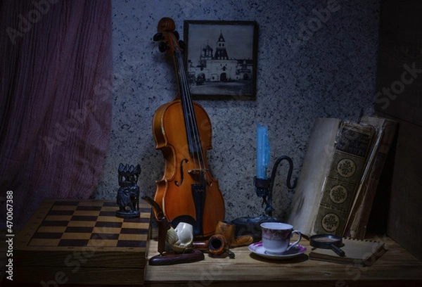 Fototapeta Retro still life with an old violin, smoking pipes, a chessboard and an elephant figure, two old books and a candle and a coffee cup