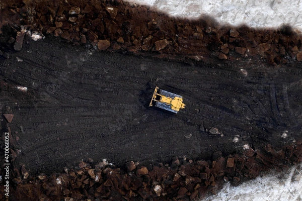Fototapeta Top down shot of bull dozer pushing Pete moss into a pile.
