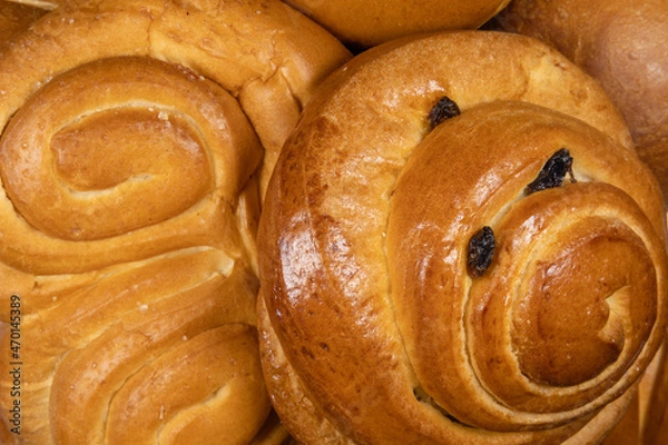 Obraz Danish bun and pretzel in the foreground of bakery or pastry composition close-up