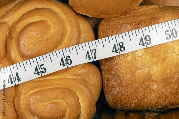Obraz The problem of excess weight. Weight problem. Measuring tape in inches over sweet pastry.  