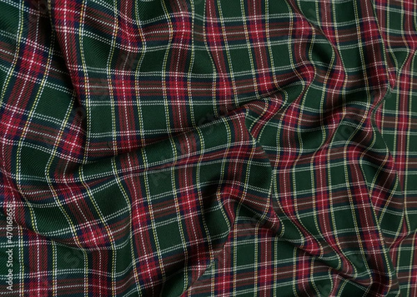 Fototapeta Green tartan woolen school uniform fabric material. Scottish classic seamless flannel cloth. Traditional wave pattern for a Christmas background or wallpaper. Black, Green, Red and White checkered.
