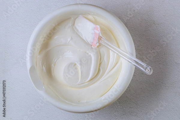 Obraz Homemade vanilla whipped cream in a white bowl.
