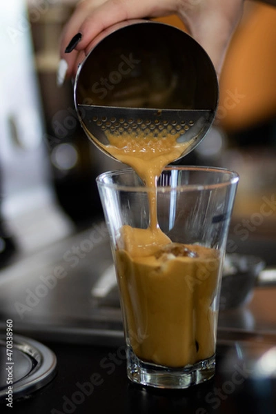 Fototapeta Espresso coffee being prepared in a small local coffee shop