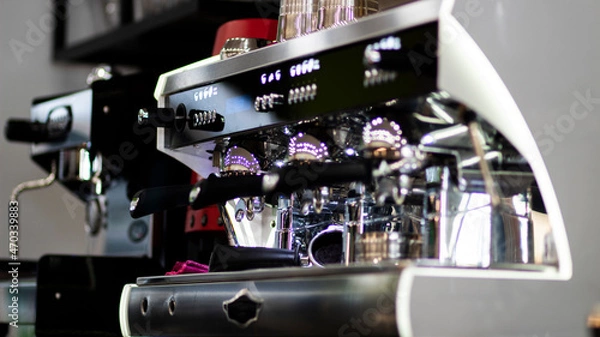 Fototapeta Close up pic of a proffesionnal coffee machine in a coffee shop preparing hot coffee