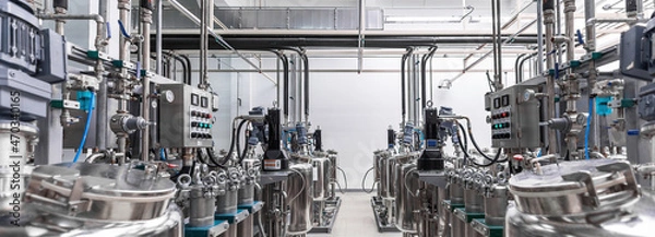 Obraz Panoramic photo of gray metal pipes and tanks. Chemistry and medicine production. Pharmaceutical factory. Interior of a high-tech factory, modern production