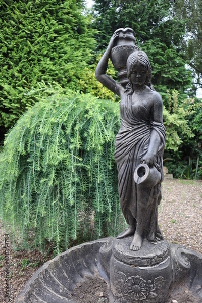 Fototapeta Statue of a lady holding jugs