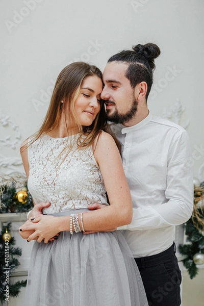 Fototapeta portrait of a couple, hugging, celebrating Christmas