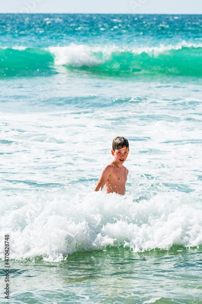 Obraz Boy playing in sea, close up, Alvor, Algarve, Portugal, Europe