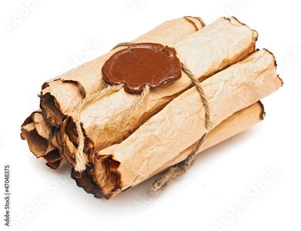 Obraz pile old paper scrolls with a wax seal on a white background