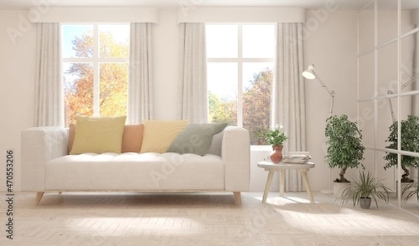 Fototapeta Stylish room in white color with sofa and autumn landscape in window. Scandinavian interior design. 3D illustration