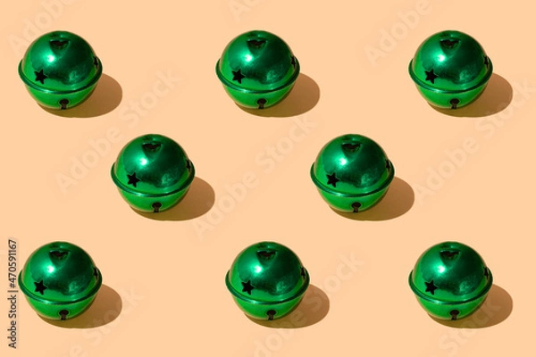 Fototapeta Christmas creative pattern made of emerald green vintage ornaments against peachy pastel background. Winter holidays and New Year retro composition. 80s or 90s fashion.