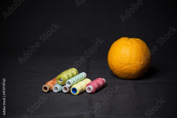 Obraz Spools of colorful thread with an orange