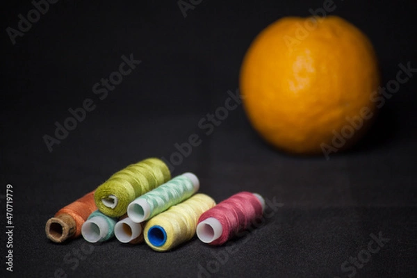Obraz Spools of colorful thread with an orange