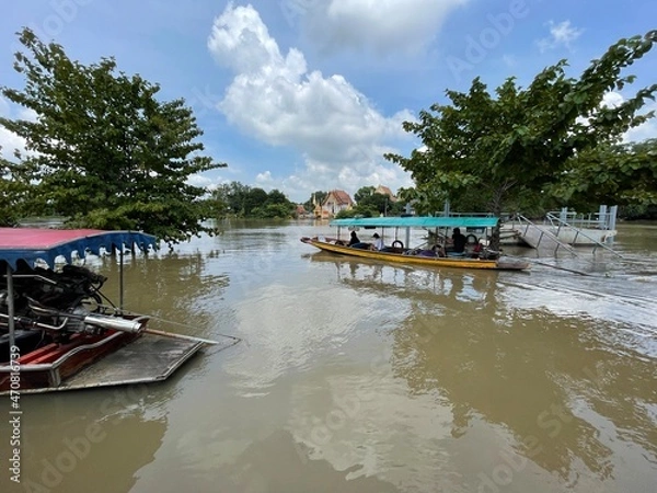 Obraz A river with boats passing through different places.