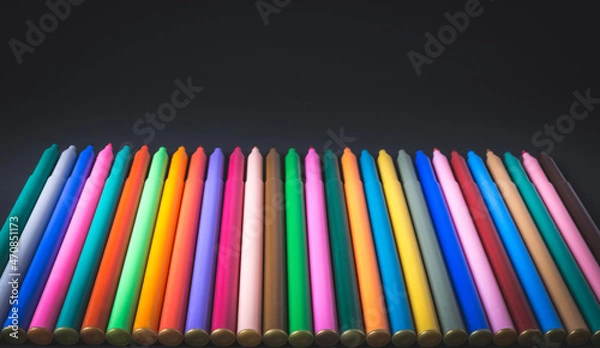 Obraz Color markers on a black background.