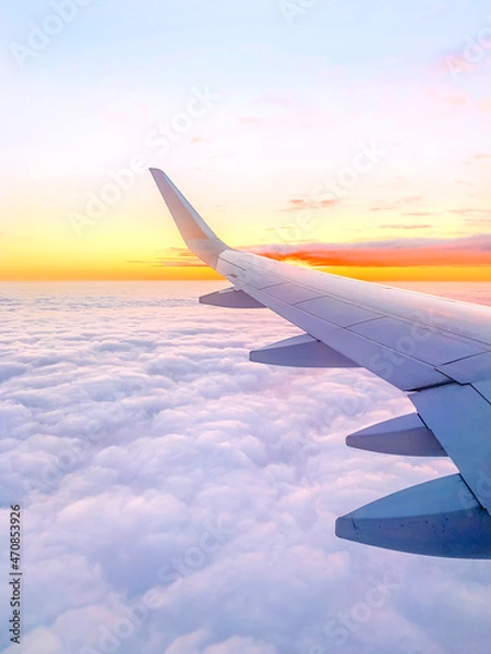 Obraz Airplane wing in the sky at beautiful sunset, airplane flight in the sky with copy space