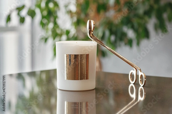 Fototapeta Golden Trimmer Candle Wick Scissors And Wax Candle On The Table in the Living Room