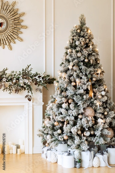 Obraz New Year's gifts under a snowy tree, beautiful white boxes with toys of light colors. Christmas presents. Fireplace.