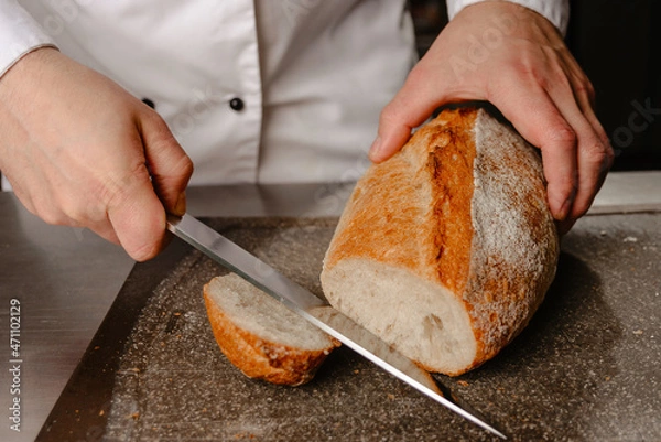 Obraz person slicing bread