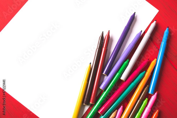 Obraz Blank white paper and color markers on wooden table.