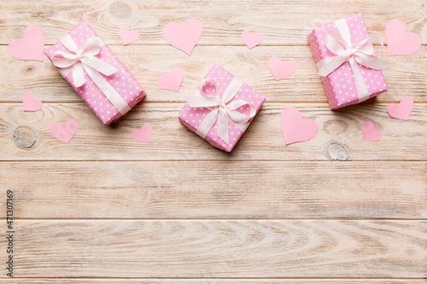 Fototapeta Valentine day composition: red gift box with bow and heart. Christmas present. View from above. Space for text. Holday greeting card