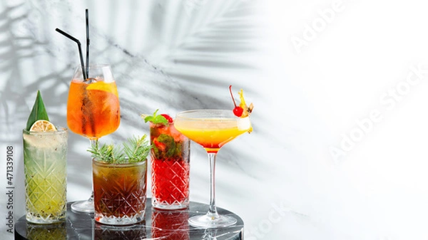 Fototapeta set cocktails on marble table and light background banner. five kinds of colorful summer cocktails in glasses and shadow of tropic branch on background. Mojito, Aperol Spritz, margarita